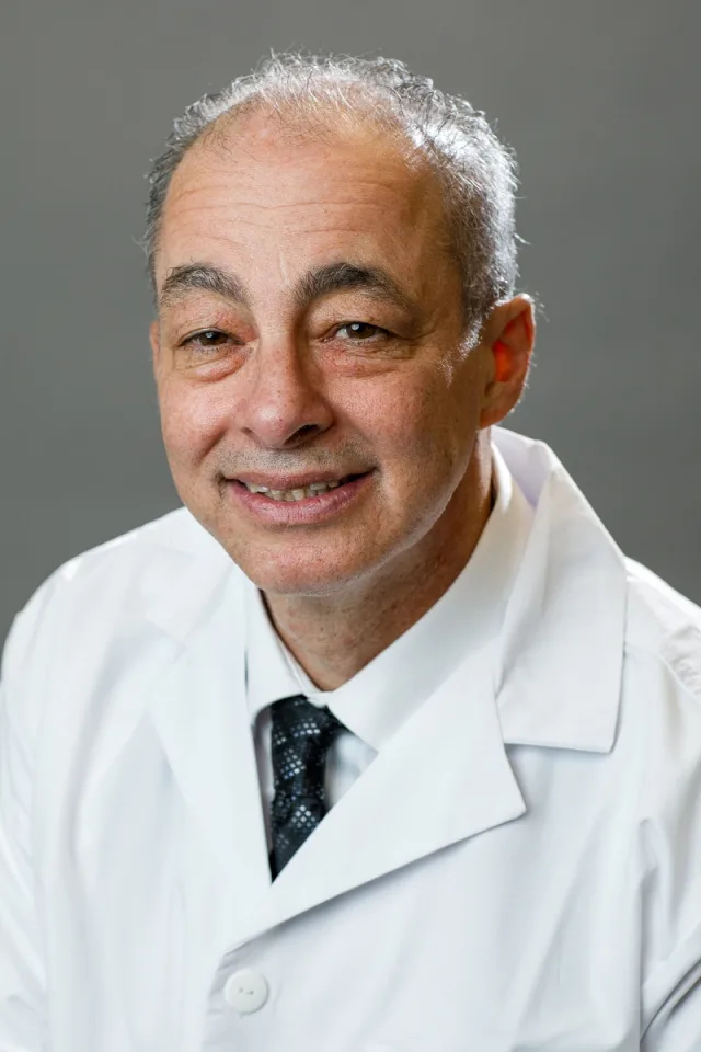 Dr. Joel Chariton, DPM, in a white lab coat
